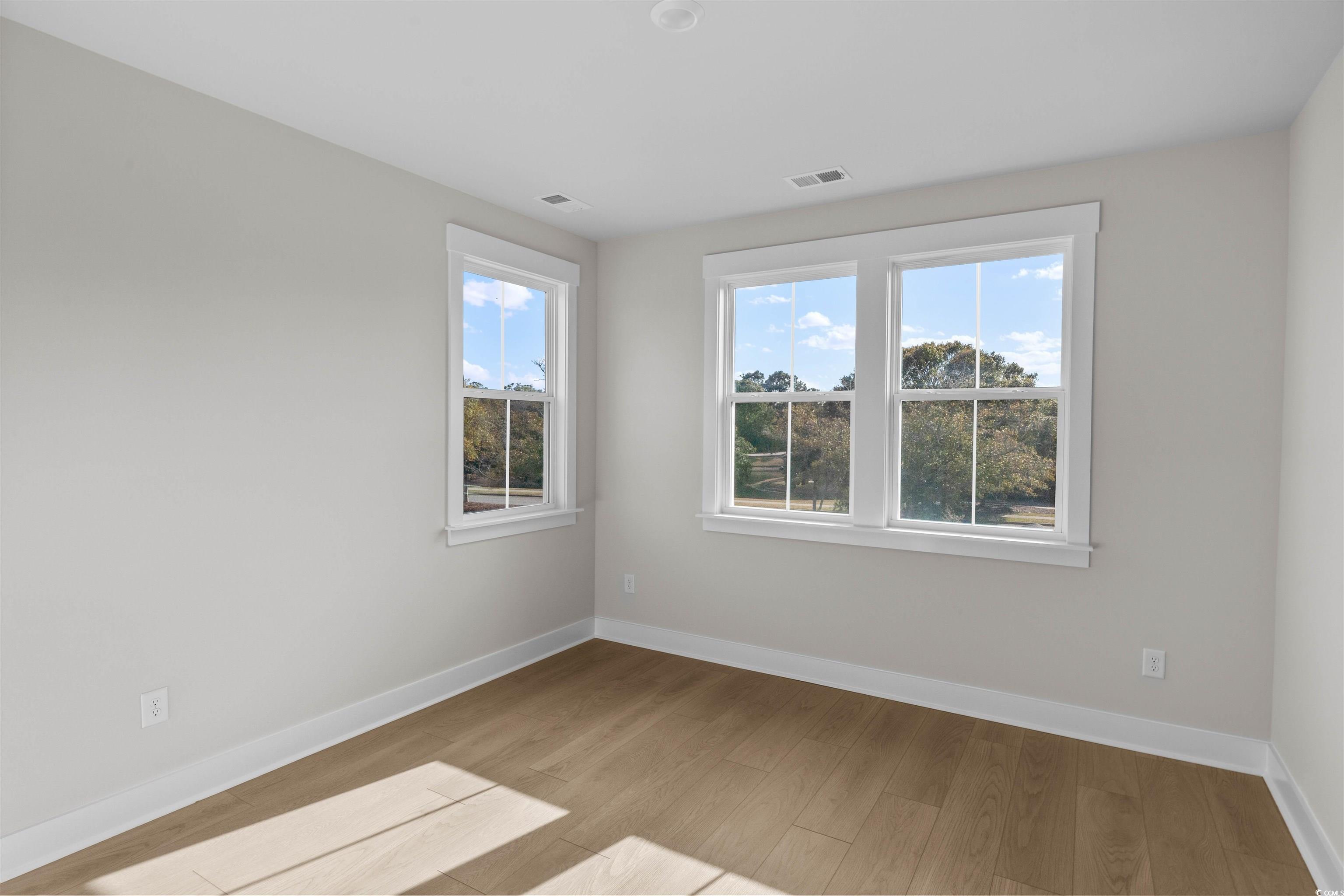 229 Atlantic Breeze Street Myrtle Beach, SC 29572 - Photo 5 of 24 Spare room with baseboards and light wood-style floors