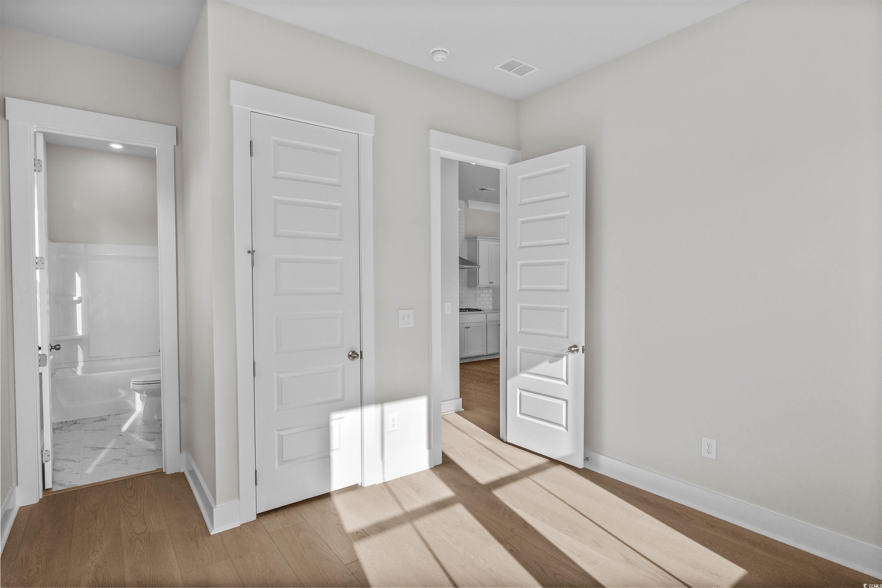 229 Atlantic Breeze Street Myrtle Beach, SC 29572 - Photo 7 of 24 Unfurnished bedroom featuring light wood-style flooring and ensuite bath