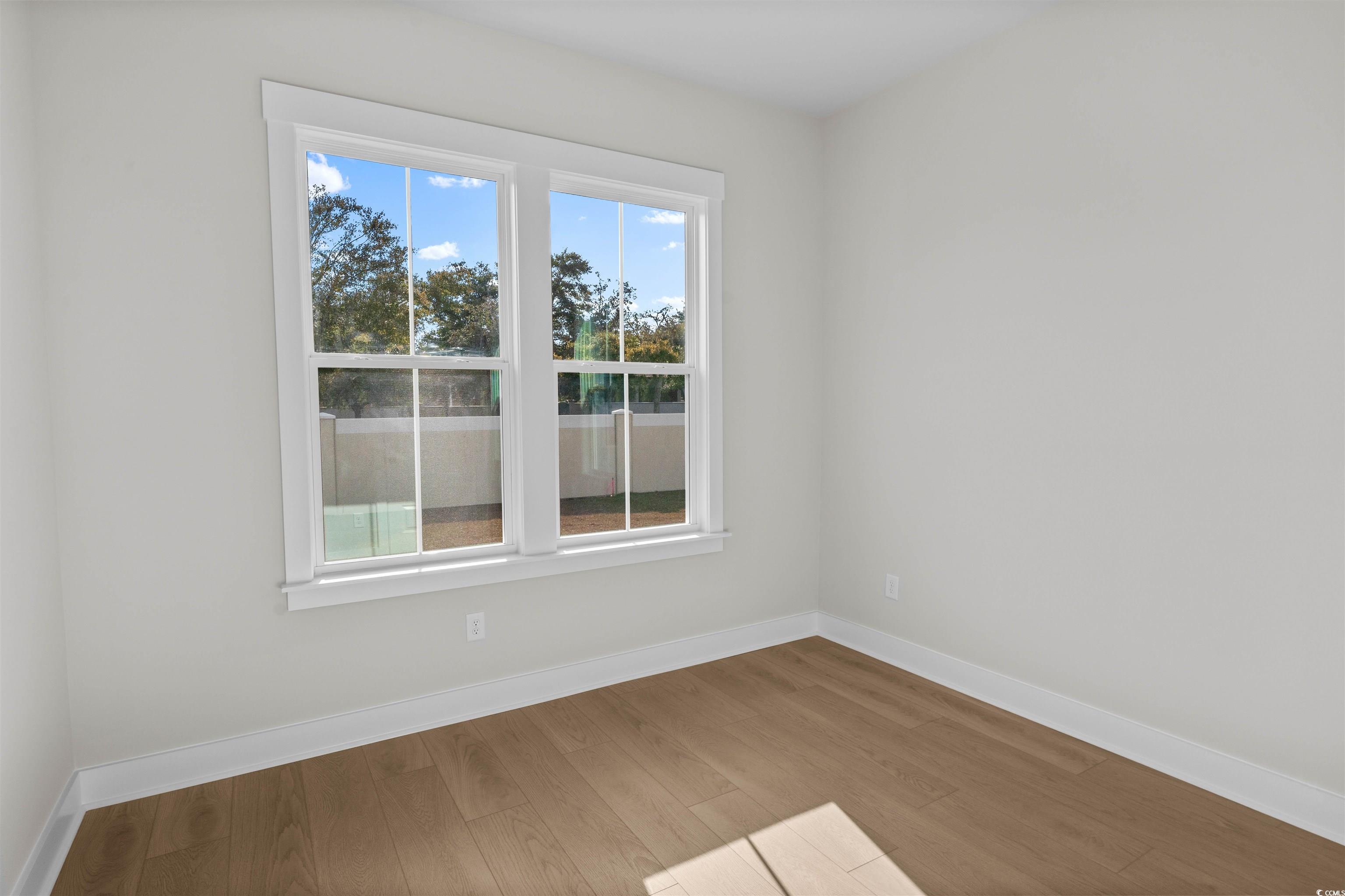 229 Atlantic Breeze Street Myrtle Beach, SC 29572 - Photo 8 of 24 Spare room featuring baseboards and wood finished floors