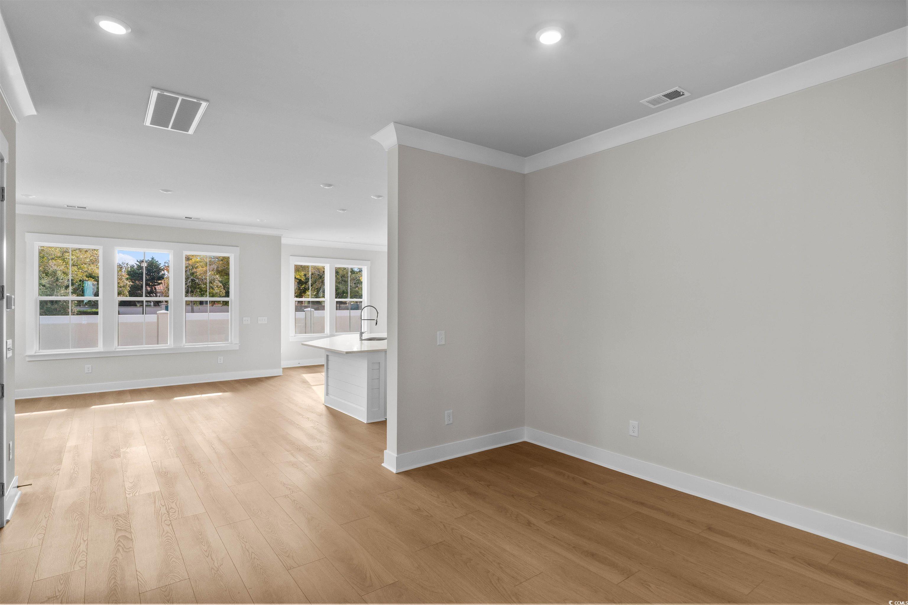 229 Atlantic Breeze Street Myrtle Beach, SC 29572 - Photo 10 of 24 Unfurnished living room with light wood-style floors, recessed lighting, and crown molding