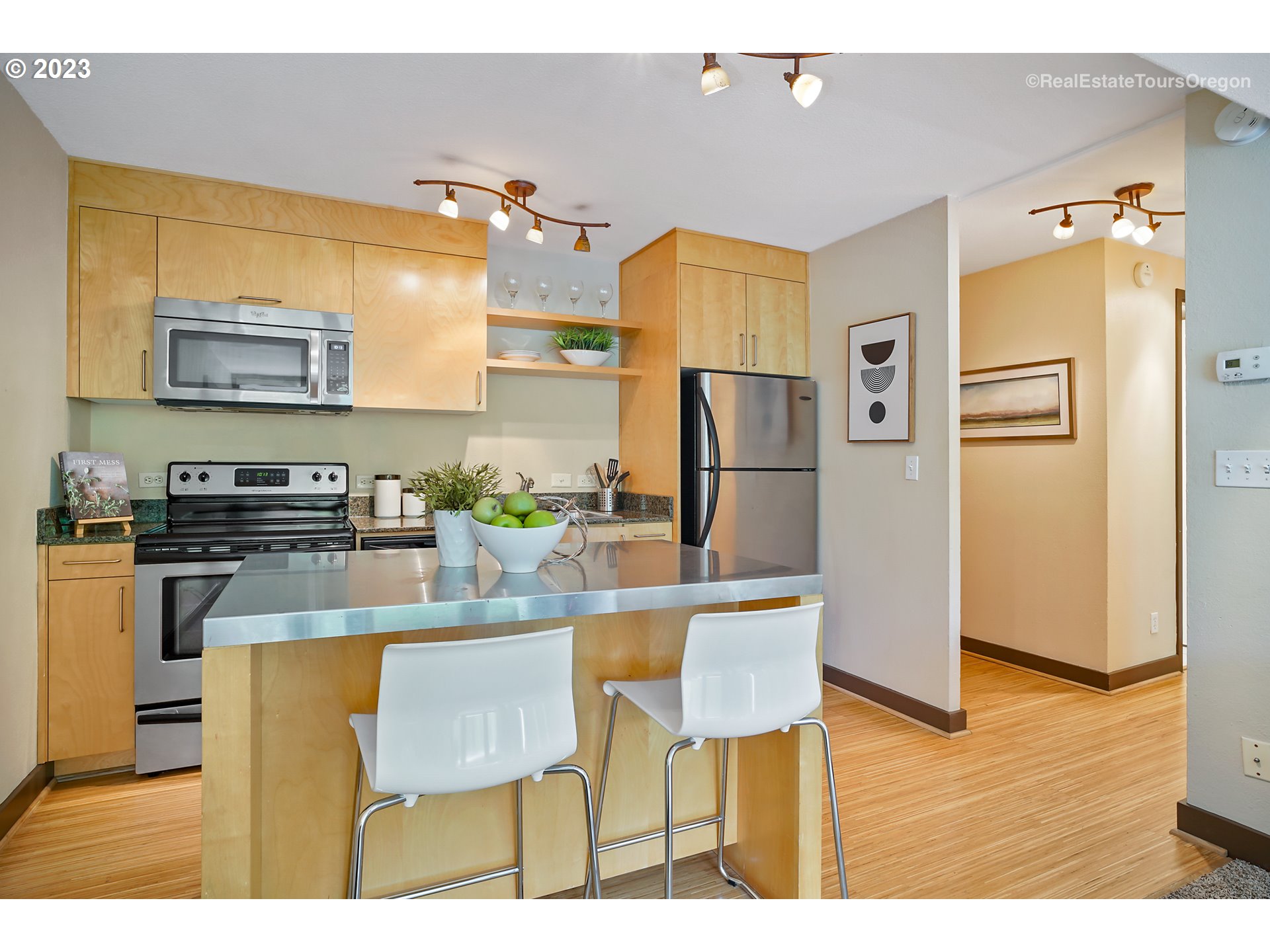 255 Southwest Harrison Street, Unit 3A Portland, OR 97201 - Photo 7 of 19 a kitchen with stainless steel appliances granite countertop a refrigerator and a stove top oven