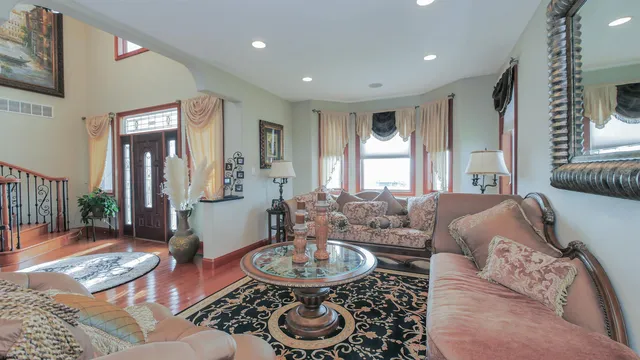 a kitchen with kitchen island granite countertop a stove refrigerator and cabinets