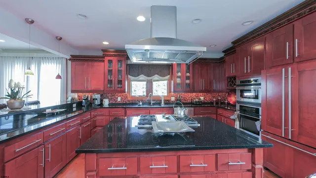 a kitchen with granite countertop a stove and cabinets