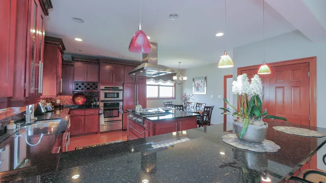 a bedroom with a bed and a flat tv screen on the dresser