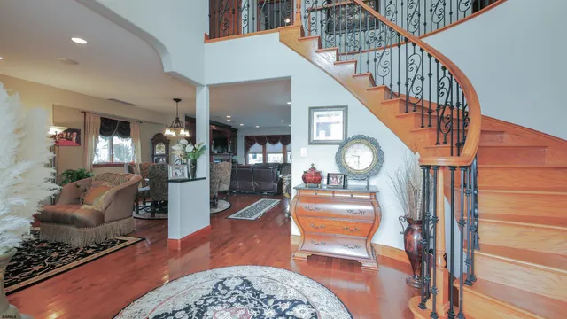 a view of entryway and hall with wooden floor