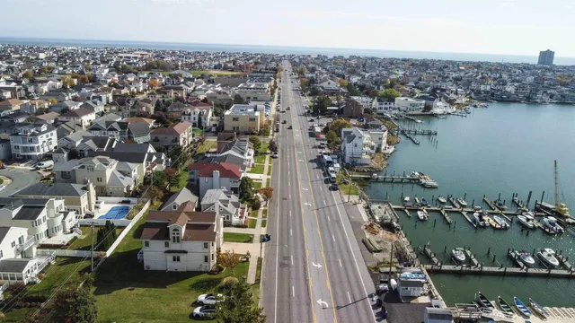 a front view of multiple houses with yard