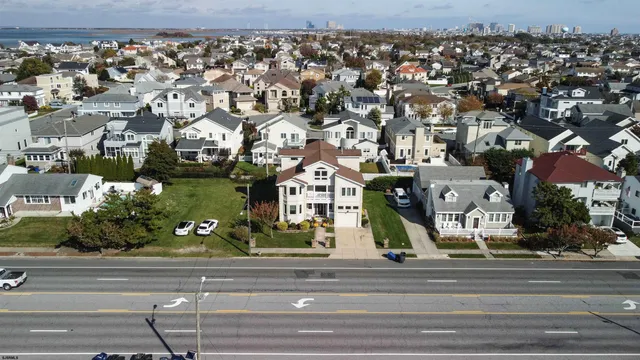 a bathroom with a granite countertop toilet a sink a mirror and a shower