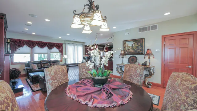 a dining room with furniture and wooden floor