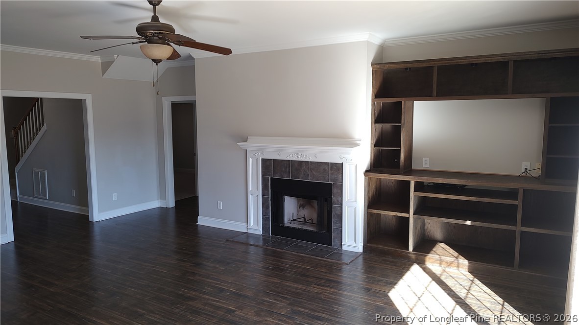 504 Brunswick Road Fayetteville, NC 28303 - Photo 12 of 50 a living room with wooden floor and a fireplace