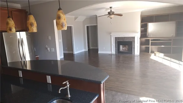 an open kitchen with furniture and a fireplace
