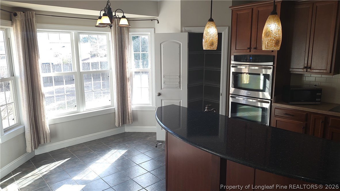 504 Brunswick Road Fayetteville, NC 28303 - Photo 18 of 50 a kitchen with stainless steel appliances granite countertop a refrigerator and a sink