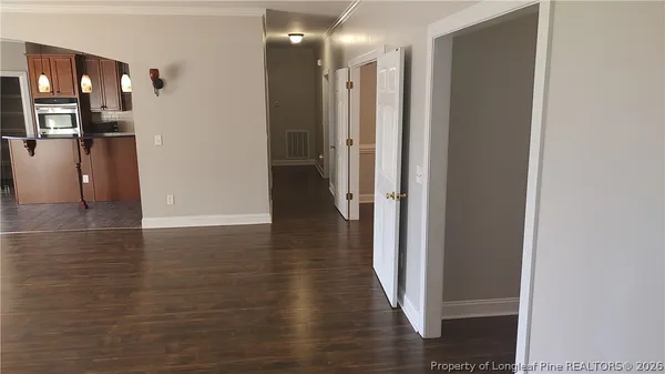 a view of a hallway with wooden floor