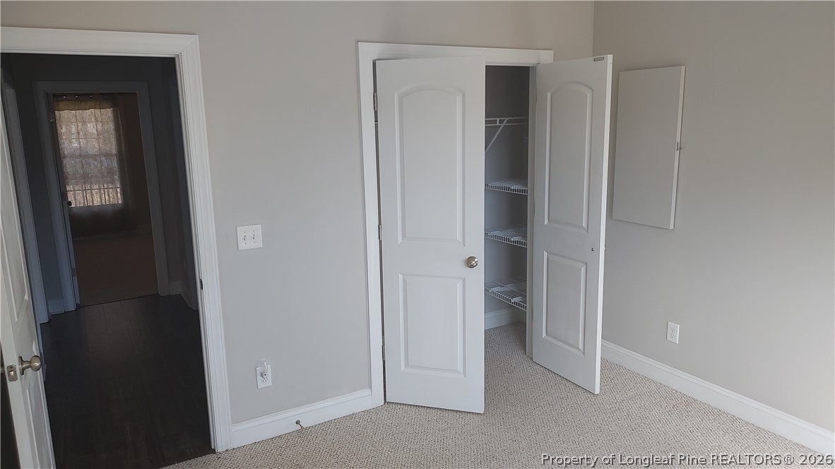 504 Brunswick Road Fayetteville, NC 28303 - Photo 23 of 50 a view of an empty room with closet and wooden door