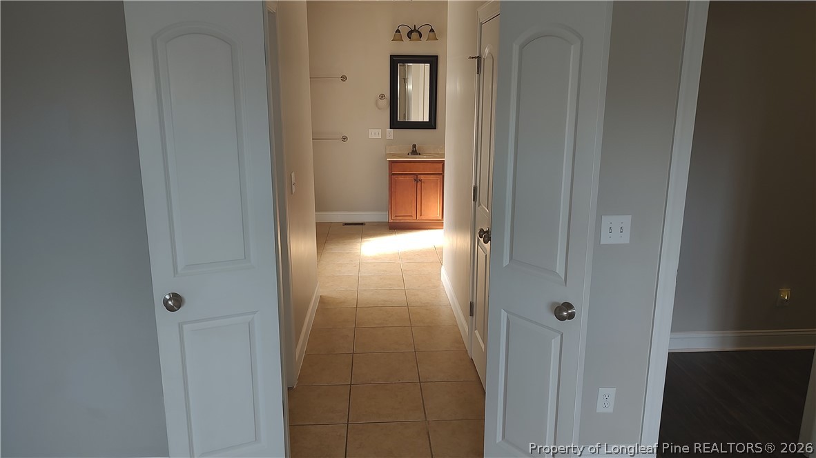 504 Brunswick Road Fayetteville, NC 28303 - Photo 34 of 50 a view of a hallway with wooden floor and a bathroom