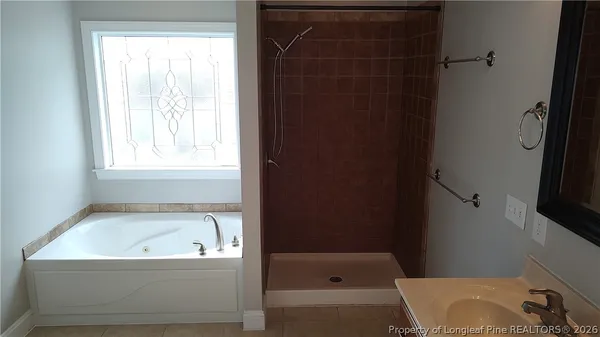 a bathroom with a bathtub and a window