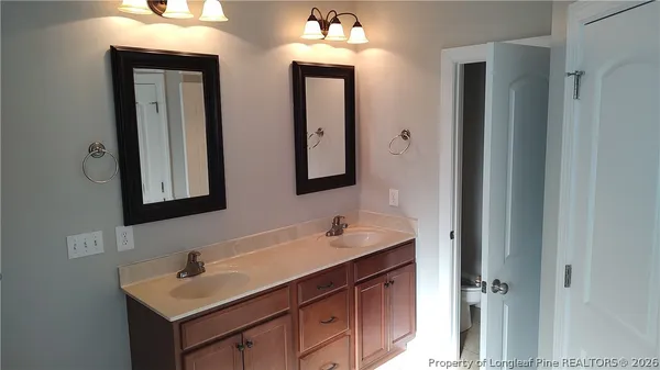 a bathroom with a sink vanity and mirror