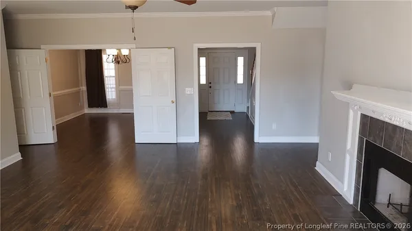a view of a hallway with wooden floor and a fireplace