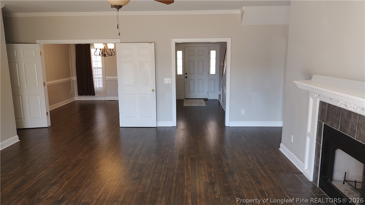 504 Brunswick Road Fayetteville, NC 28303 - Photo 9 of 50 a view of a hallway with wooden floor and a fireplace