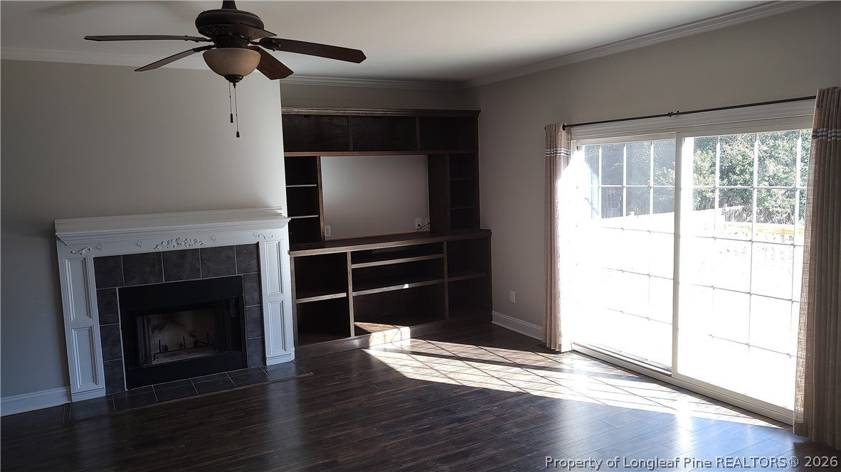 504 Brunswick Road Fayetteville, NC 28303 - Photo 10 of 50 a living room with wooden floor a fireplace and windows