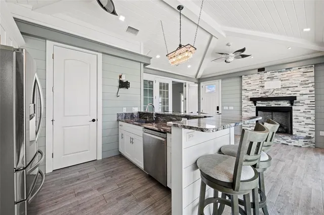 a bathroom with a toilet a sink a vanity and mirror