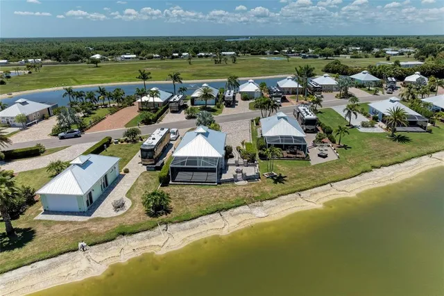 a kitchen with stainless steel appliances granite countertop a stove top oven a refrigerator and a dining table with wooden floor