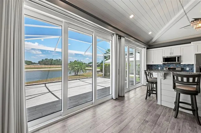 a bathroom with a granite countertop tub sink and mirror