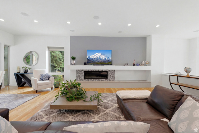 1389 Millbrook Way Bountiful, UT 84010 - Photo 22 of 74 Bright living area featuring wood-finish flooring, recessed lighting, and a contemporary fireplace with a mosaic tile surround