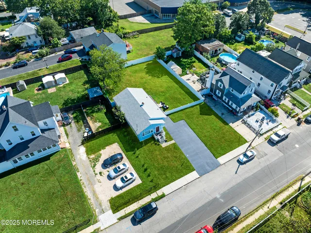 an aerial view of a house with a garden and swimming pool