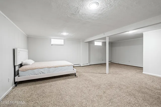 a spacious bedroom with a bed and a cabinets