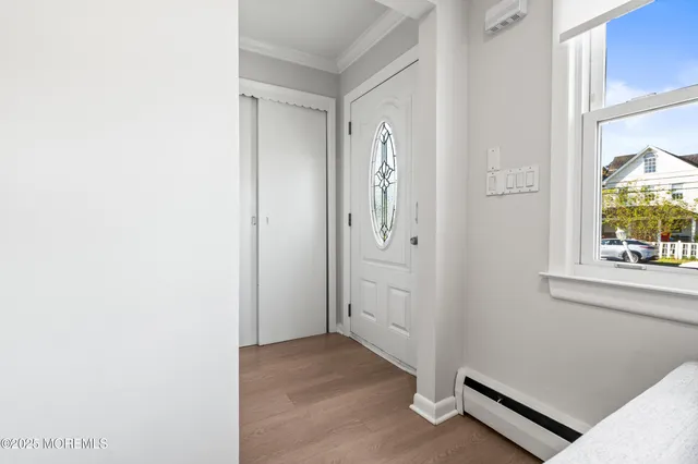 a view of front door with wooden floor