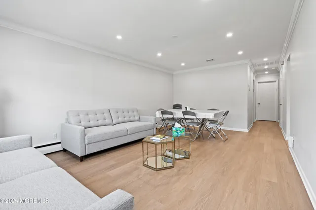 a living room with furniture and white wooden floor