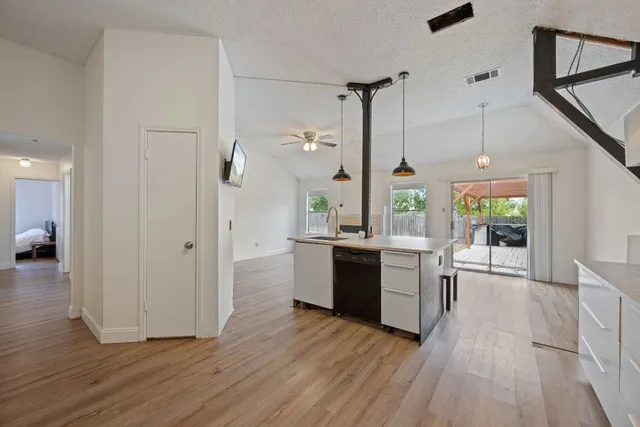 a kitchen with a refrigerator and a stove top oven
