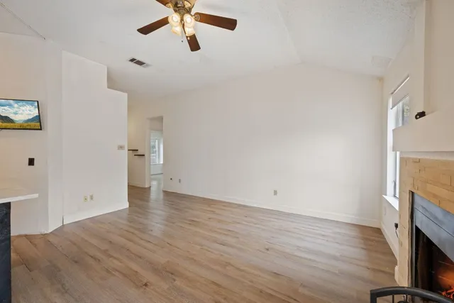 wooden floor in an empty room with a fireplace
