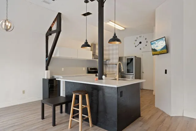 a view of a kitchen with appliances and a wooden floor