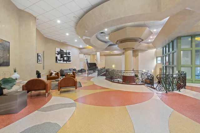 a view of a lobby with furniture and floor to ceiling window