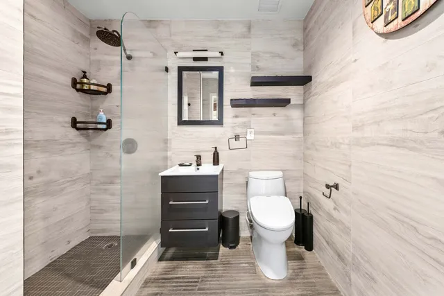 a bathroom with a toilet and a shower