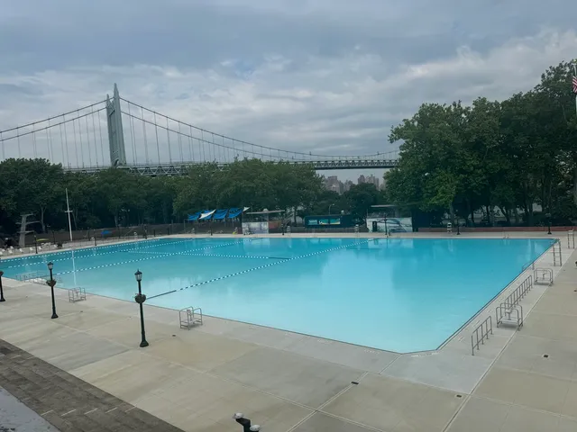 a view of a lake with a floor to ceiling window and wooden fence