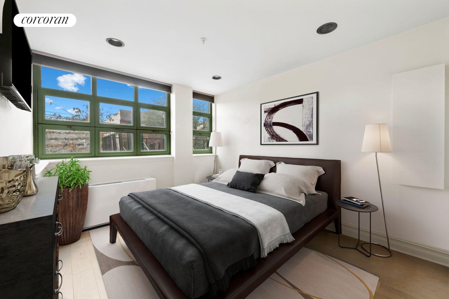 19-19 24th Avenue, Unit 102 Queens, NY 11102 - Photo 6 of 36 a bedroom with a bed and a couch