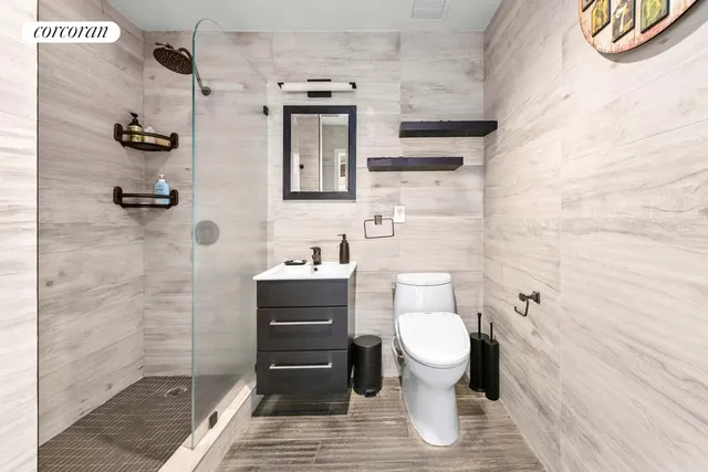 a bathroom with a toilet and a shower