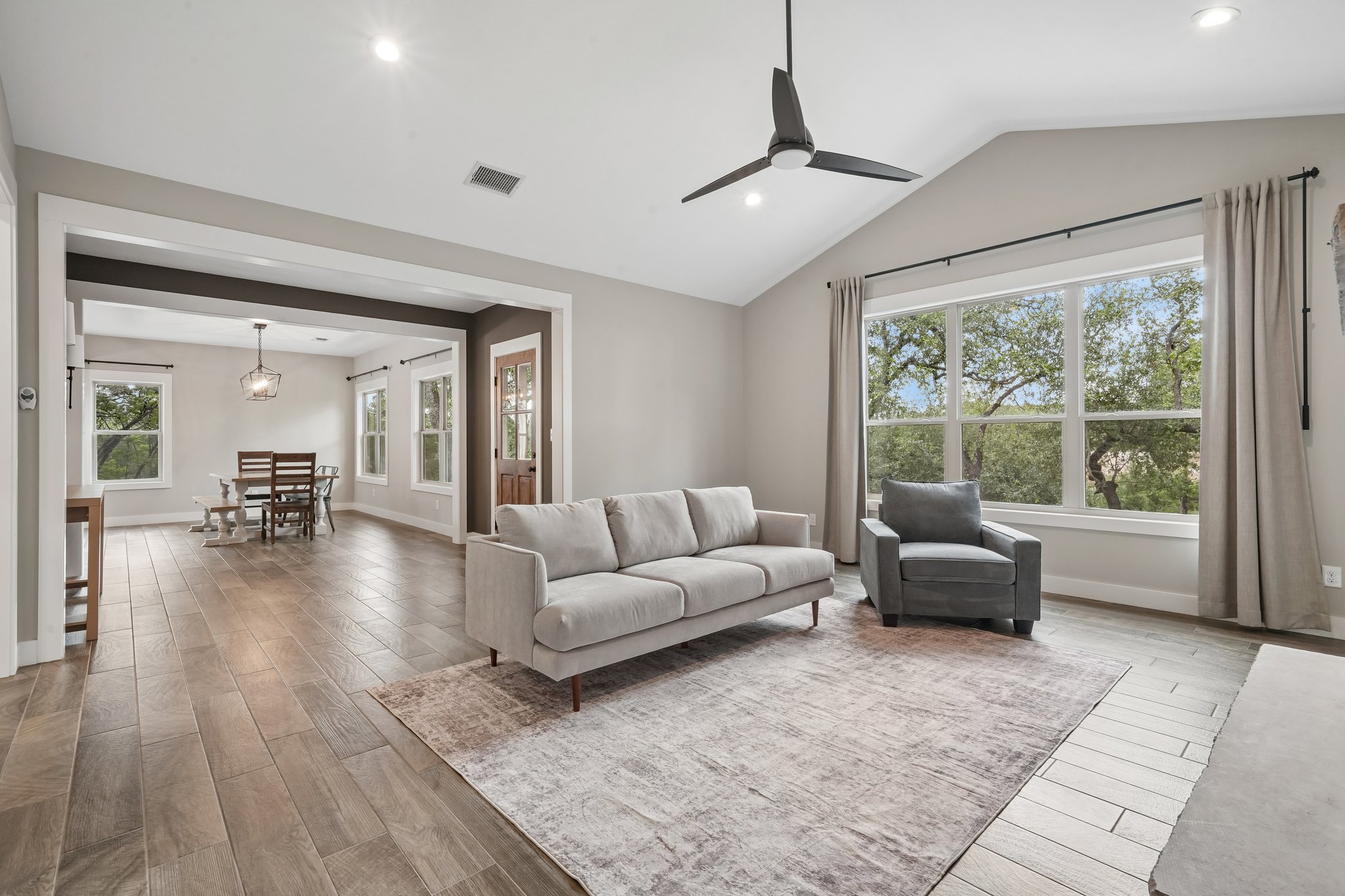 190 Magnolia Meadow Spring Branch, TX 78070 - Photo 3 of 29 Vaulted ceilings and wood-look tile flooring unite a spacious living area and a charming dining room.