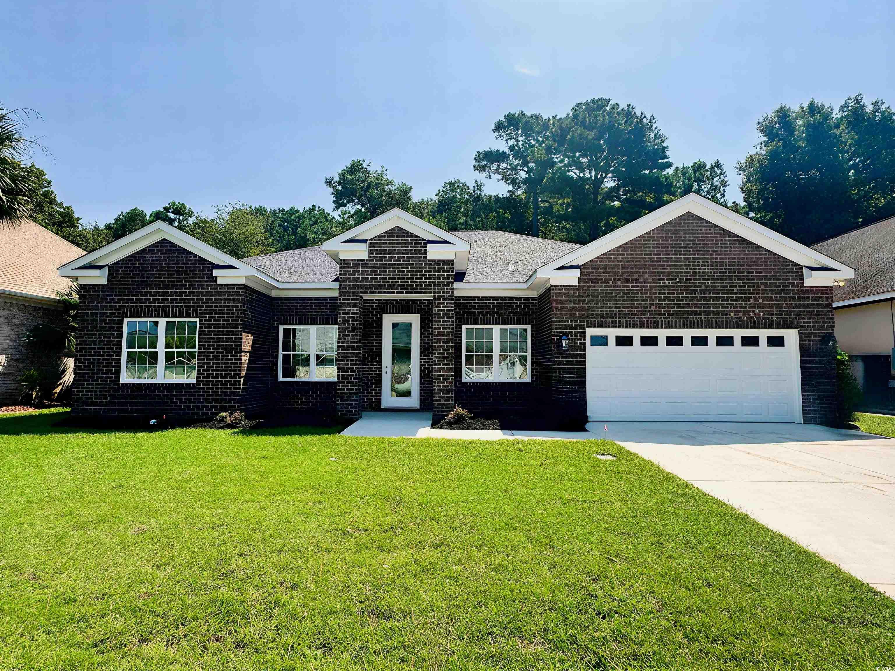 309 Waterfall Circle Little River, SC 29566 - Photo 2 of 40 Ranch-style house with a garage, brick siding, a front yard, and concrete driveway