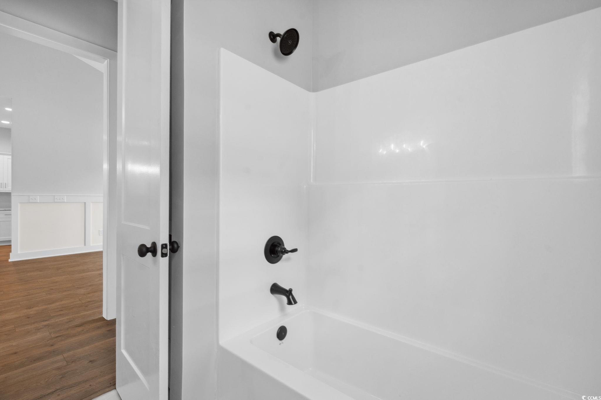 309 Waterfall Circle Little River, SC 29566 - Photo 22 of 40 Bathroom featuring wood finished floors and shower / washtub combination