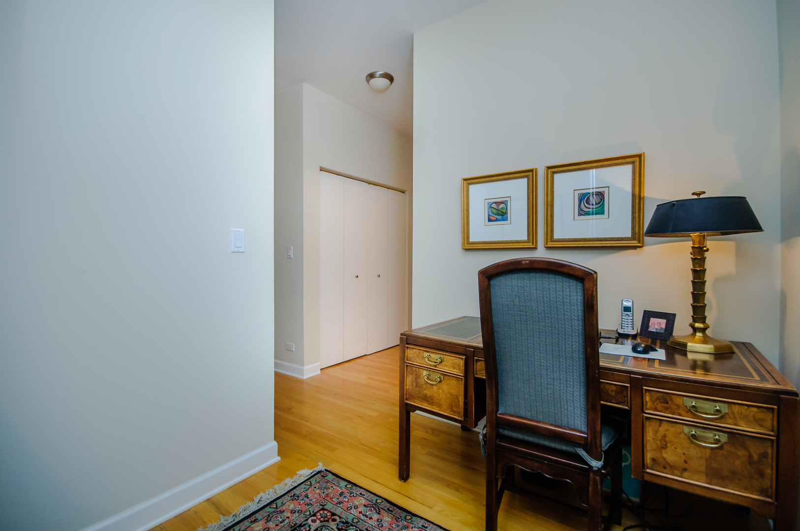 4646 North Beacon Street, Unit 203 Chicago, IL 60640 - Photo 18 of 24 a living room with furniture and a lamp