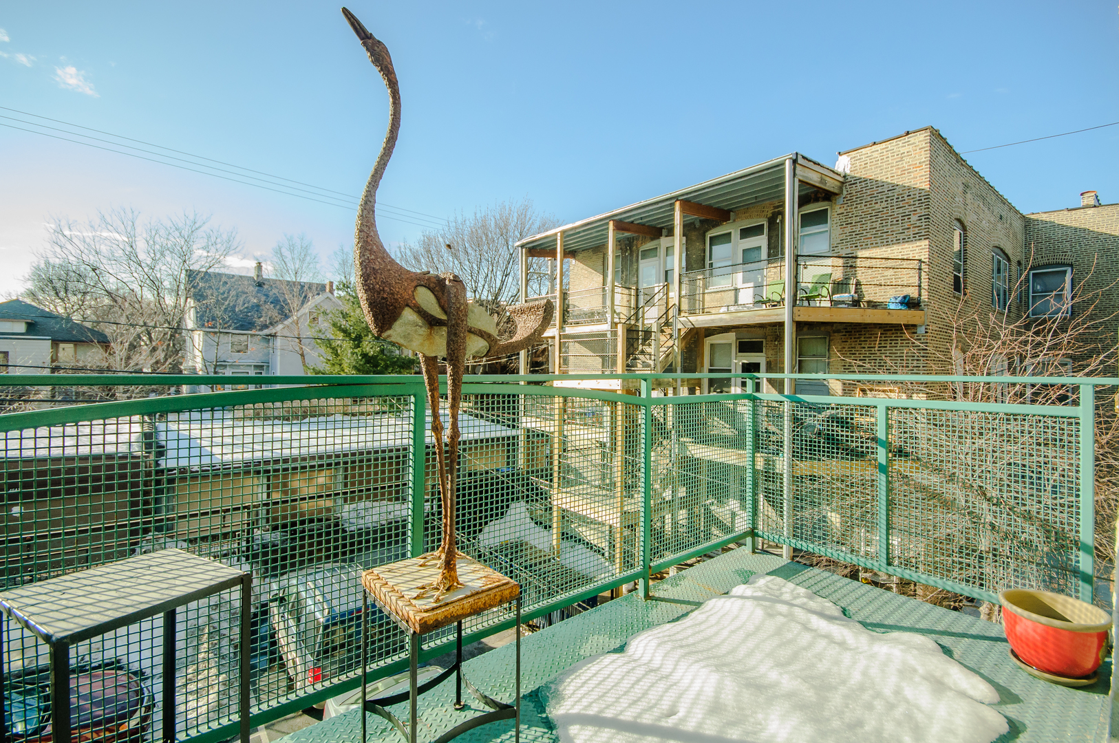 4646 North Beacon Street, Unit 203 Chicago, IL 60640 - Photo 22 of 24 a balcony with table and chairs