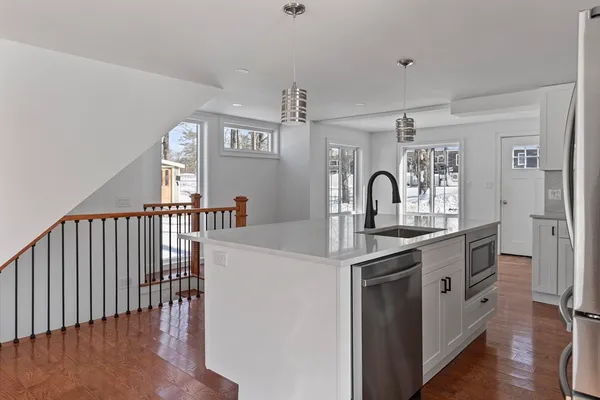 a kitchen with cabinets a sink and appliances