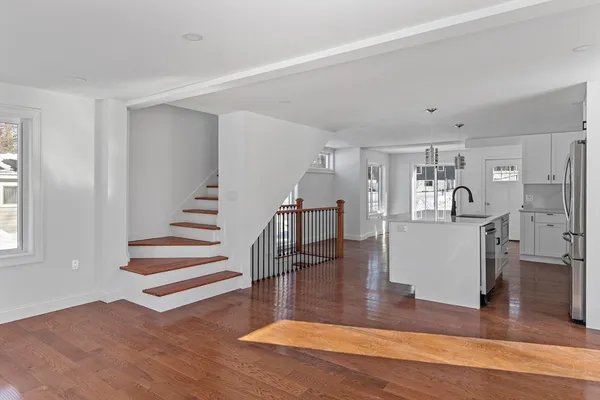 a view of entryway and hall with wooden floor