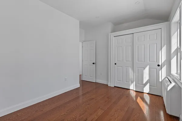 a view of a room with wooden floor