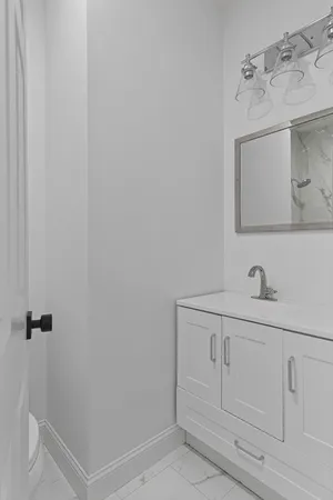 a bathroom with a sink a vanity and mirror