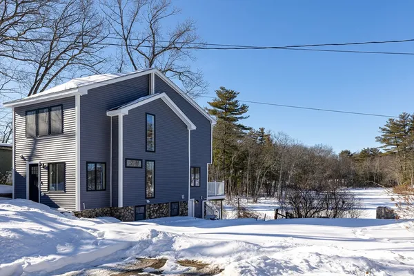 a view of a house with a snow on the road