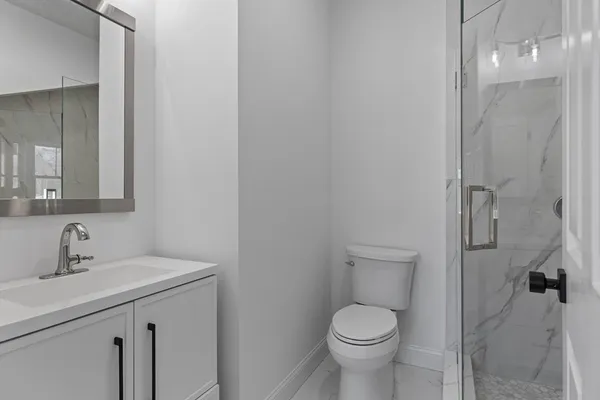 a bathroom with a toilet sink and shower